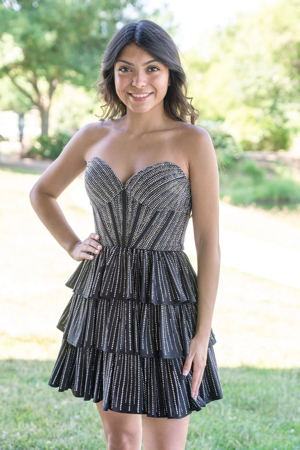 A line sweetheart strapless mini Dress with rhinestone embellishment, corset bodice, tiered ruffle skirt, and lace up back